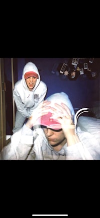 a man in a white hoodie and a woman in a pink hoodie